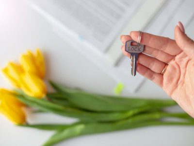 Woman holding key to a home sold in the spring